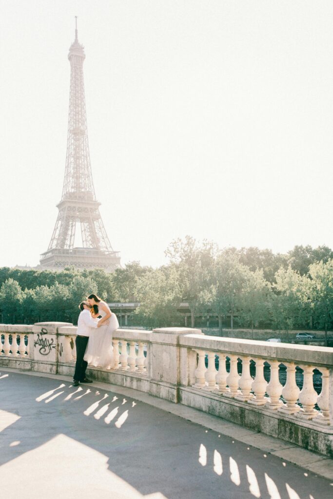 pexels photo 18156060 18156060 A couple embraces on a bridge with the iconic Eiffel Tower in the background, embodying romance in Paris.