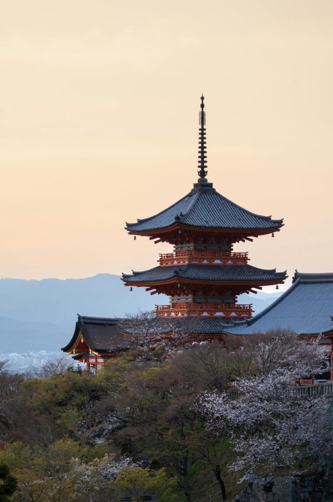 pexels photo 32207826 32207826 Captivating view of Kiyomizu-dera Pagoda surrounded by sakura blossoms at sunset in Kyoto, Japan.